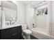 Bathroom featuring a tub and shower with white scalloped tile and a modern black vanity at 25392 Westridge Rd, Golden, CO 80403