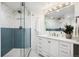 Bathroom featuring a glass shower with herringbone tile and a white vanity with sleek hardware at 25392 Westridge Rd, Golden, CO 80403