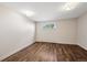 Minimalist bedroom features laminate flooring, white trim, neutral walls and natural light at 25392 Westridge Rd, Golden, CO 80403