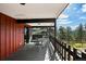 Covered deck with outdoor seating, ideal for enjoying the surrounding natural beauty at 25392 Westridge Rd, Golden, CO 80403