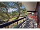 Deck space offering beautiful views of surrounding wooded areas and natural landscaping at 25392 Westridge Rd, Golden, CO 80403