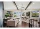 Bright and airy dining room with floor-to-ceiling windows, hardwood floors, and stylish furnishings at 25392 Westridge Rd, Golden, CO 80403