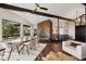 Elegant dining room with a stone fireplace, hardwood floors, and plenty of natural light at 25392 Westridge Rd, Golden, CO 80403