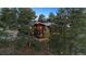 Stunning multi-story home nestled amongst tall trees, with a cozy and inviting mountain ambiance at 25392 Westridge Rd, Golden, CO 80403