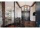 Grand foyer with a stunning spiral staircase and stone wall, creating an elegant entrance at 25392 Westridge Rd, Golden, CO 80403