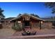 Charming home featuring a stone facade, peaked roof, and inviting outdoor seating area with a fire pit at 25392 Westridge Rd, Golden, CO 80403
