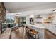 Bright kitchen with granite counters, stainless appliances, wood floors, island seating, and access to the outdoors at 25392 Westridge Rd, Golden, CO 80403