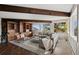 Living room with hardwood floors, custom built in bookcases, gray sectional, and mountain views at 25392 Westridge Rd, Golden, CO 80403