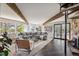 Spacious living room with exposed wood beams, stylish furnishings, and scenic outdoor views at 25392 Westridge Rd, Golden, CO 80403