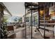 Spacious living room with a gray sectional, wood floors, large windows with views, and spiral staircase at 25392 Westridge Rd, Golden, CO 80403