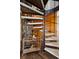 Unique spiral staircase next to stone accent wall and wet bar at 25392 Westridge Rd, Golden, CO 80403
