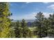 Scenic view of mountain tops, clear blue skies, and lush green trees at 25392 Westridge Rd, Golden, CO 80403