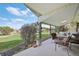 Covered back porch with outdoor dining area and views of the landscaped yard at 4152 S Vrain St, Denver, CO 80236