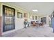Enjoy this covered back porch area with a table and chairs, and views of the yard at 4152 S Vrain St, Denver, CO 80236