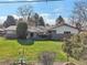Lush backyard with mature trees, patio area, and well-maintained lawn at 4152 S Vrain St, Denver, CO 80236