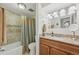 Bathroom featuring granite countertop, wood vanity, and a shower/tub with decorative curtain at 4152 S Vrain St, Denver, CO 80236