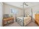 Bedroom featuring neutral decor, plantation shutters, and metal bedframe at 4152 S Vrain St, Denver, CO 80236