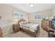 Bedroom featuring neutral decor, plantation shutters, and side tables at 4152 S Vrain St, Denver, CO 80236