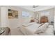 Bedroom featuring neutral decor, plantation shutters, and a ceiling fan at 4152 S Vrain St, Denver, CO 80236