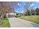 Single-story home with a driveway leading to an attached two-car garage and a manicured front lawn at 4152 S Vrain St, Denver, CO 80236