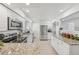 Bright kitchen featuring stainless steel appliances, white cabinetry, and granite countertops at 4152 S Vrain St, Denver, CO 80236
