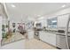 Open concept kitchen and dining area featuring stainless appliances and light tile floors at 4152 S Vrain St, Denver, CO 80236