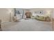Bright living room featuring comfortable seating, decorative cabinet, and soft carpet at 4152 S Vrain St, Denver, CO 80236