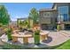 Cozy backyard patio featuring stone benches, potted plants, and a pergola, perfect for outdoor relaxation and entertaining at 6590 S Tabor St, Littleton, CO 80127
