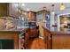 Finished bar area with wood cabinets, stylish lighting, and ample counter space at 6590 S Tabor St, Littleton, CO 80127