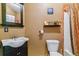 Functional bathroom with a vanity sink, toilet, and a shower with a curtain at 6590 S Tabor St, Littleton, CO 80127