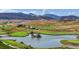Scenic view of a well-manicured golf course with a pond, surrounded by rolling hills and mountain vistas at 6590 S Tabor St, Littleton, CO 80127