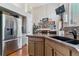 Open kitchen with stainless steel refrigerator, double sink, and sleek cabinets offering modern convenience and style at 6590 S Tabor St, Littleton, CO 80127