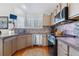 Well-equipped kitchen featuring stainless steel appliances, ample counter space, and stylish backsplash at 6590 S Tabor St, Littleton, CO 80127