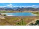 Expansive lake and dam surrounded by rolling hills and mountain views, offering recreational opportunities and natural beauty at 6590 S Tabor St, Littleton, CO 80127
