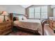 Cozy main bedroom with a comfortable bed, natural light, and wood floors at 6590 S Tabor St, Littleton, CO 80127