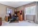 A functional office space featuring a wooden desk, ergonomic chair, and natural light at 6590 S Tabor St, Littleton, CO 80127