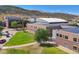 A modern school building with solar panels, lush green spaces, and walkways offers a sustainable and inviting atmosphere at 6590 S Tabor St, Littleton, CO 80127