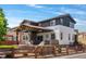 Attractive backyard with a covered patio, a fire pit with Adirondack chairs, and a well-manicured lawn and garden at 14110 Pastel Ln, Parker, CO 80134