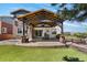 Spacious backyard with a covered patio, an outdoor kitchen, a dining area, and a well-maintained lawn at 14110 Pastel Ln, Parker, CO 80134