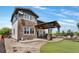 Stunning backyard with a stone patio, a covered pergola, and lush landscaping at 14110 Pastel Ln, Parker, CO 80134