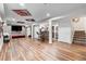 Spacious basement featuring a bar area with stools, a large entertainment space with a TV, and wood-look flooring at 14110 Pastel Ln, Parker, CO 80134