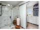 Bathroom with glass-enclosed shower featuring a marble tile surround and a walk-in closet at 14110 Pastel Ln, Parker, CO 80134