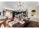 Open concept dining and kitchen area with an elegant chandelier and a dining table that seats six at 14110 Pastel Ln, Parker, CO 80134