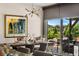 Bright dining room with a modern chandelier, a large dining table, and sliding glass doors to the outside patio at 14110 Pastel Ln, Parker, CO 80134