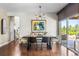 Elegant dining room with modern chandelier, artwork, and sliding doors to an outdoor patio at 14110 Pastel Ln, Parker, CO 80134