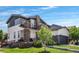 Charming two-story home with a manicured lawn, stone accents, and a covered front porch at 14110 Pastel Ln, Parker, CO 80134