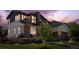 Attractive two-story home featuring stone accents, a covered porch, and professional landscaping at 14110 Pastel Ln, Parker, CO 80134