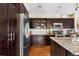 Modern kitchen with stainless steel appliances, dark cabinetry and granite countertops at 14110 Pastel Ln, Parker, CO 80134