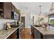Open-concept kitchen with granite countertops, stainless steel appliances, and views into the dining room at 14110 Pastel Ln, Parker, CO 80134