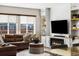 Welcoming living room with a cozy fireplace, built-in shelves, and a comfortable brown leather sofa at 14110 Pastel Ln, Parker, CO 80134